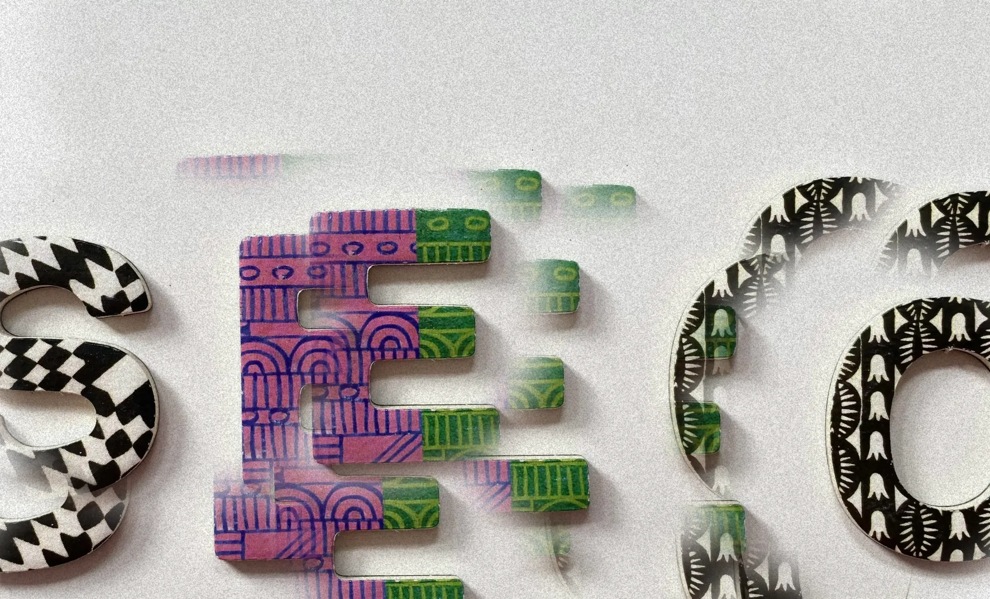 An abstract and defragmented artwork of three patterned letters spelling out as "SEO"